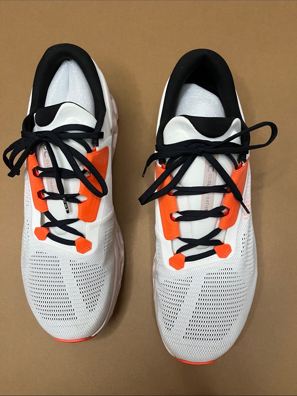 On Running men’s White Sneakers with Orange Accents